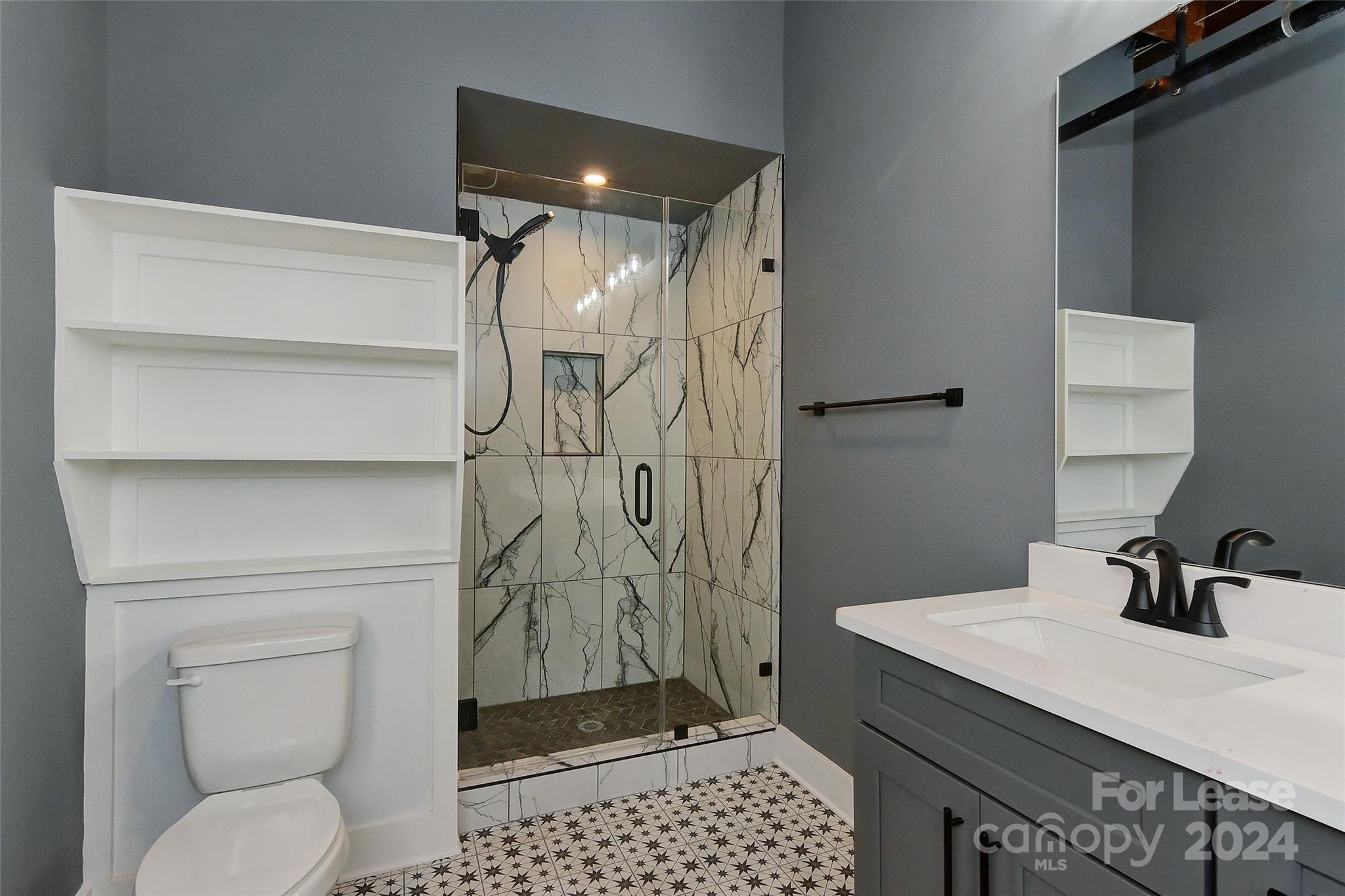115 South Main Street, Unit 202 Monroe, NC 28112 - Photo 10 of 25 a bathroom with a shower a toilet and a sink