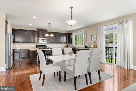 a view of kitchen with cabinets table and chairs