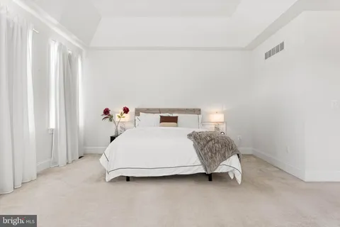 a bedroom with a bed and a television