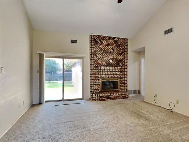a view of an empty room with a fireplace