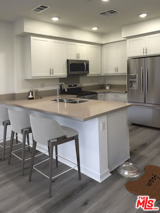 170 Tarragon Way Upland, CA 91786 - Photo 3 of 17 a kitchen with appliances cabinets and a sink