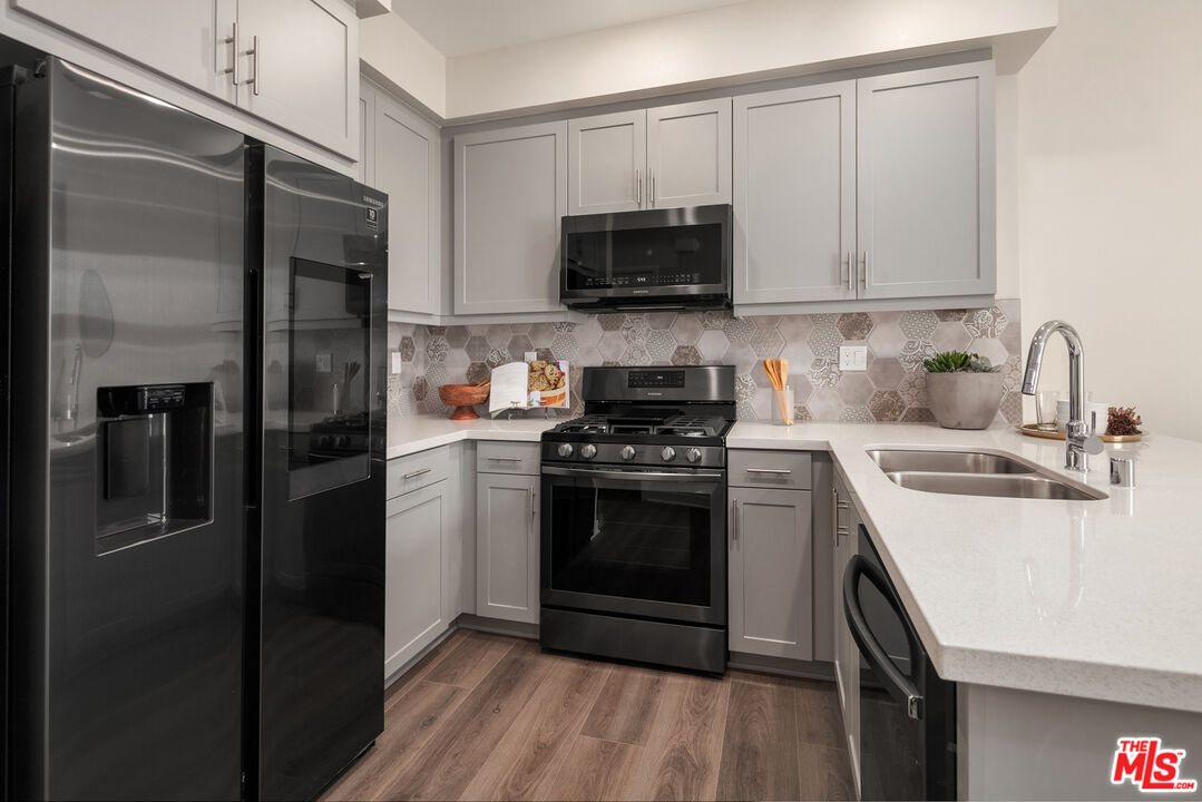 170 Tarragon Way Upland, CA 91786 - Photo 6 of 17 a kitchen with stainless steel appliances a sink stove and refrigerator