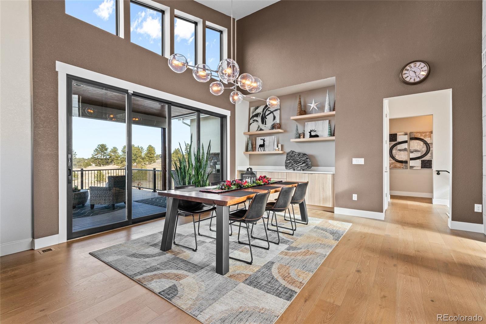 10205 Inspiration Drive Parker, CO 80138 - Photo 12 of 50 a view of a dining room with furniture window and wooden floor