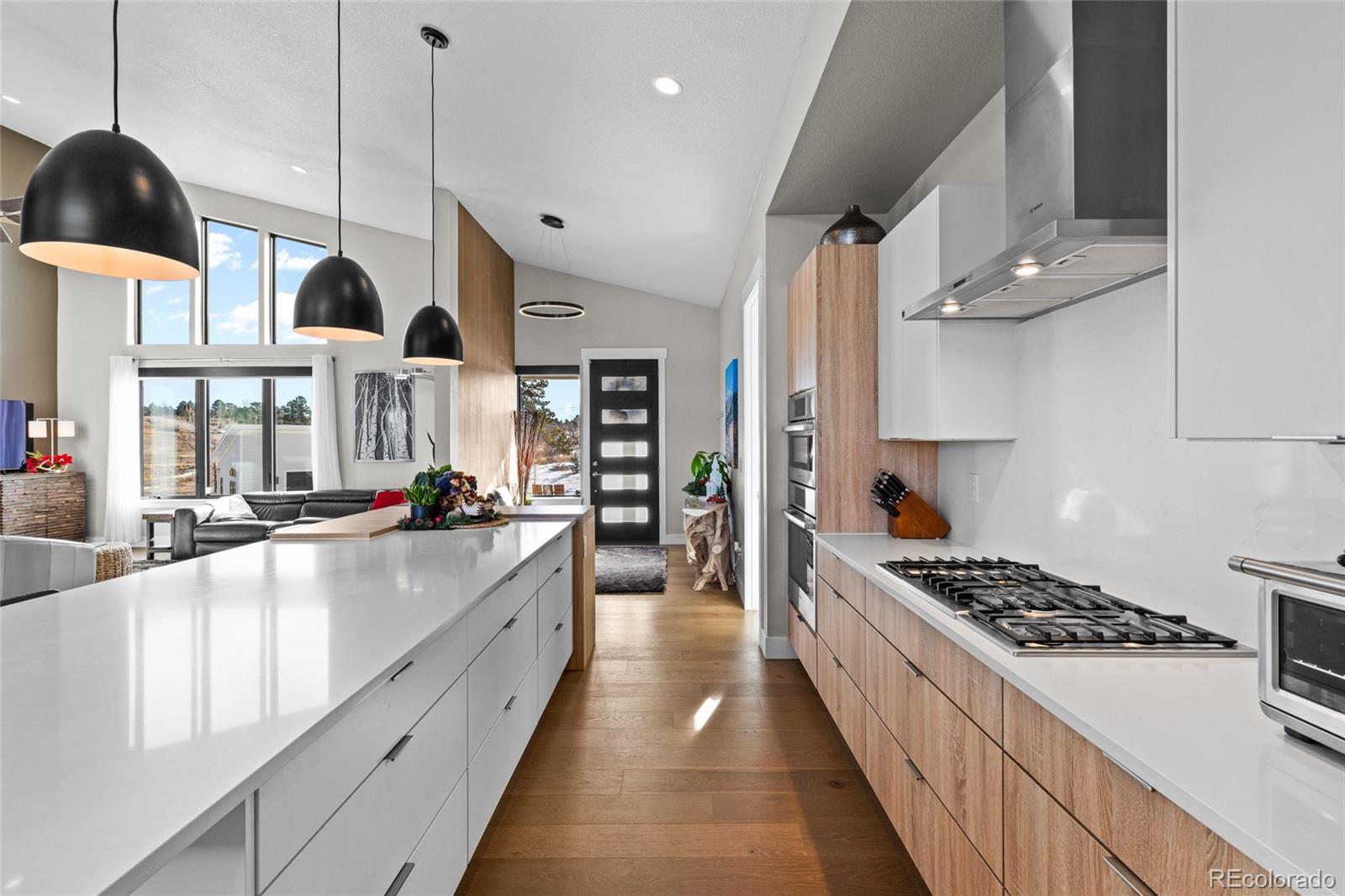10205 Inspiration Drive Parker, CO 80138 - Photo 16 of 50 a kitchen with stainless steel appliances kitchen island a large counter space a sink and a large window