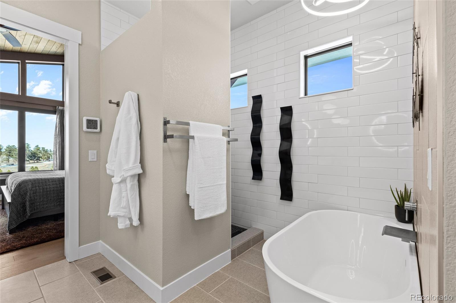 10205 Inspiration Drive Parker, CO 80138 - Photo 28 of 50 a bathroom with a tub a sink and a shower