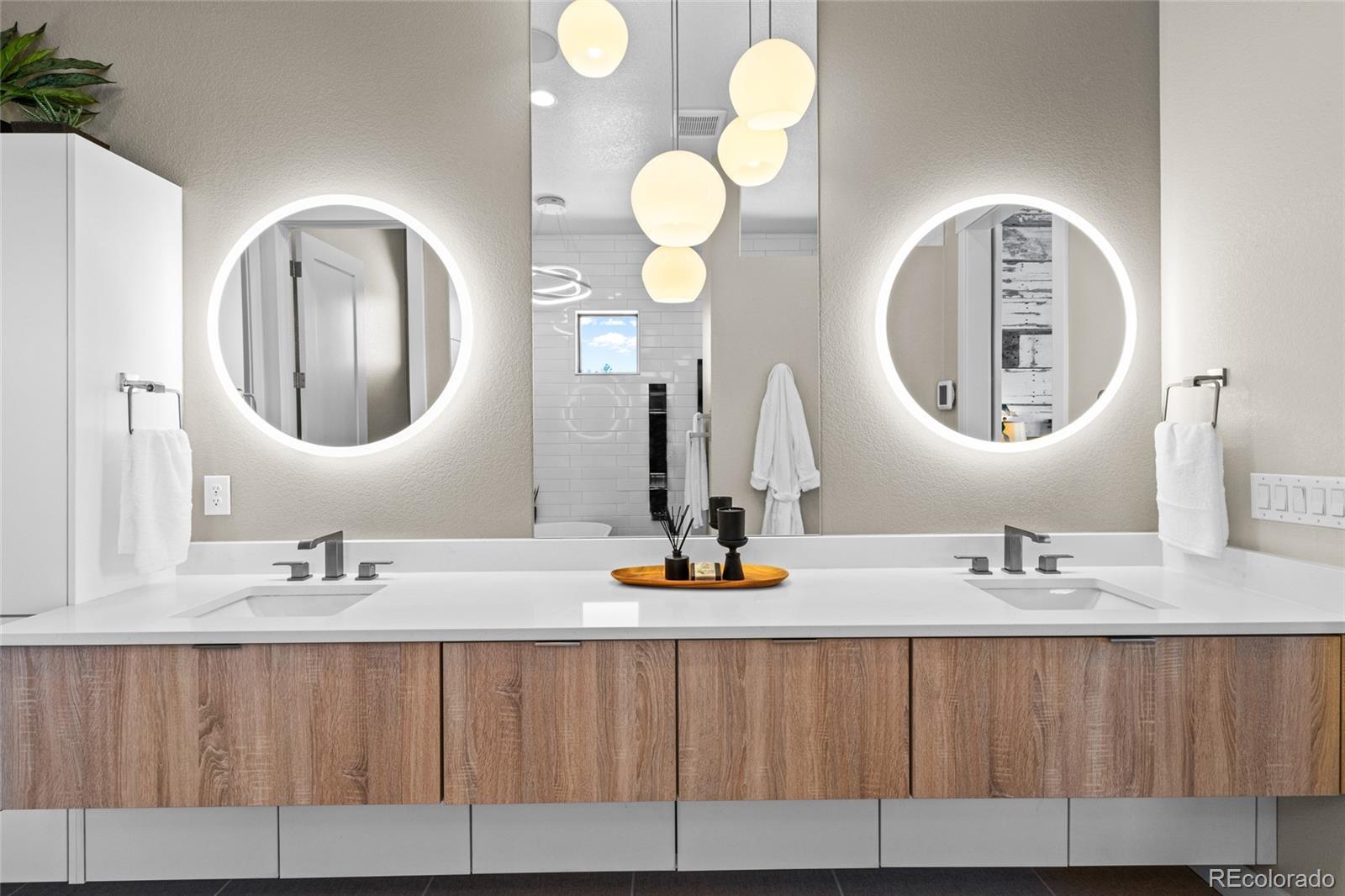 10205 Inspiration Drive Parker, CO 80138 - Photo 29 of 50 a bathroom with a sink and a mirror