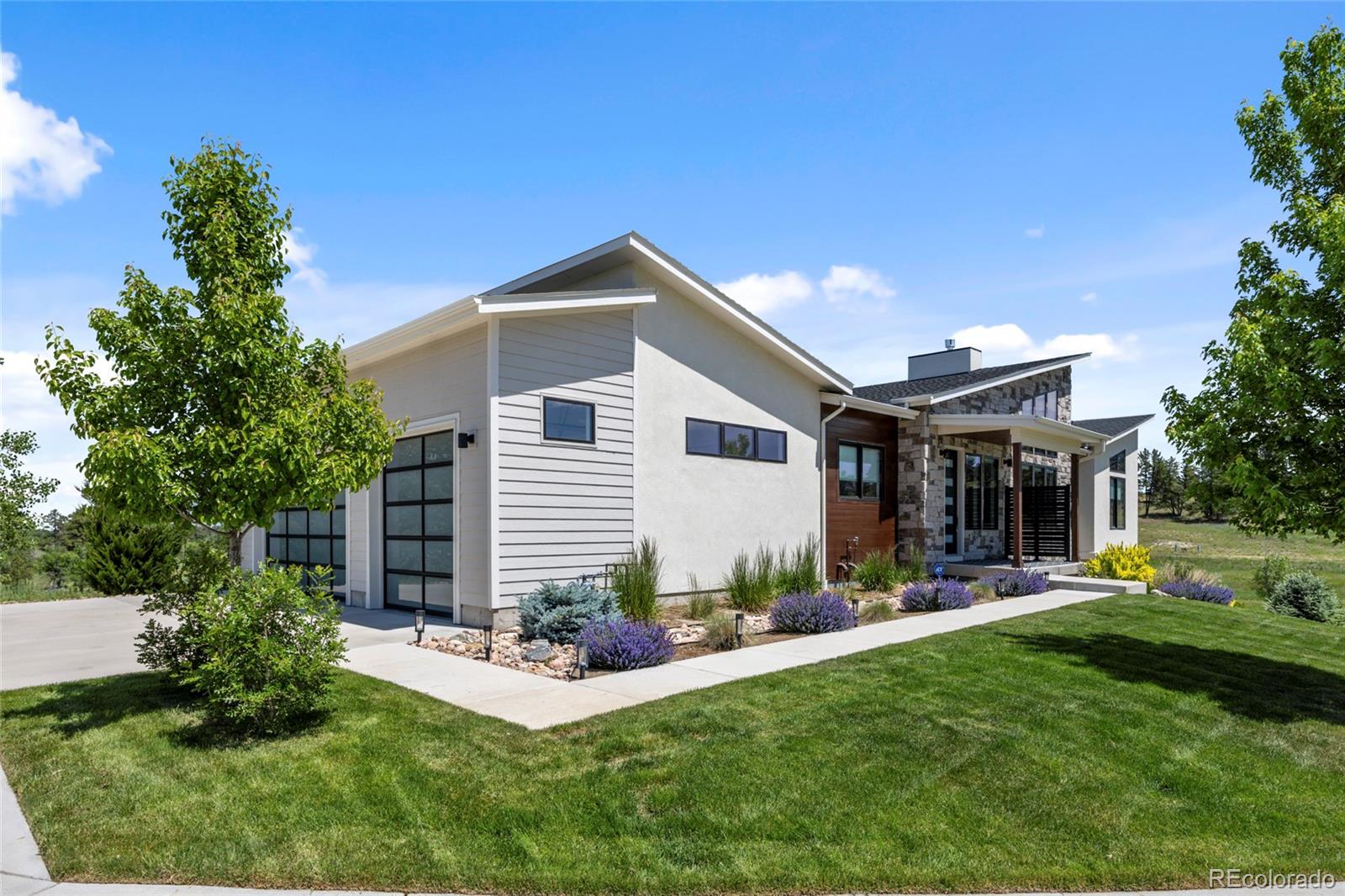 10205 Inspiration Drive Parker, CO 80138 - Photo 3 of 50 a front view of house with yard and outdoor seating