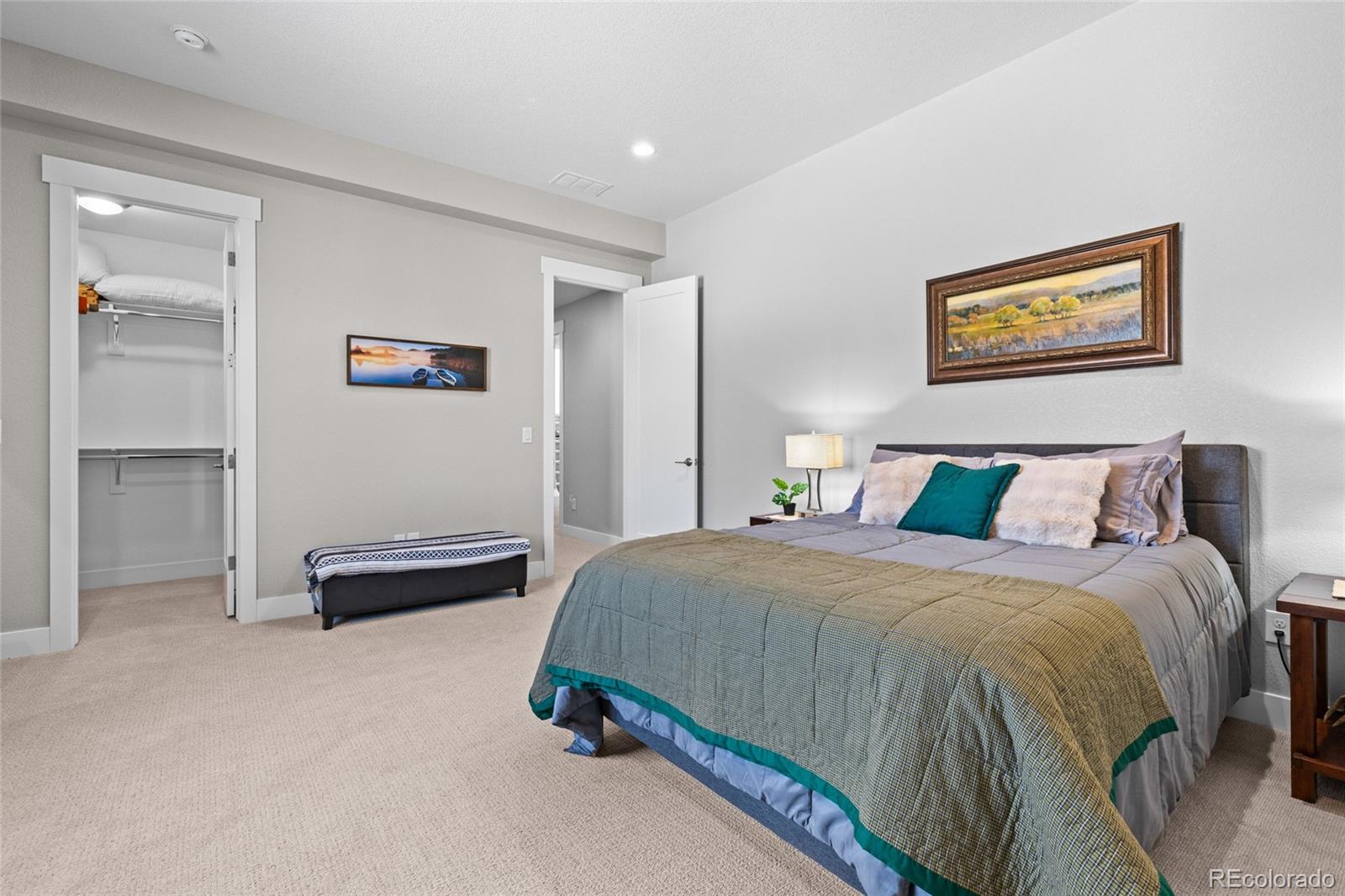 10205 Inspiration Drive Parker, CO 80138 - Photo 37 of 50 a spacious bedroom with a bed and a table