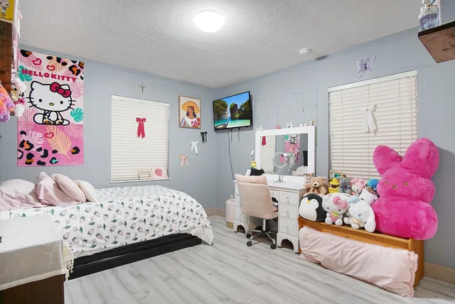 a bedroom with a bed and a couch