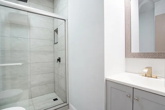 a bathroom with a shower and a sink
