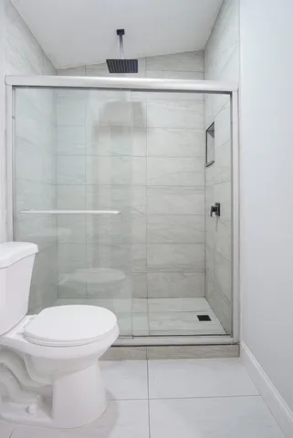 a bathroom with a shower and a toilet