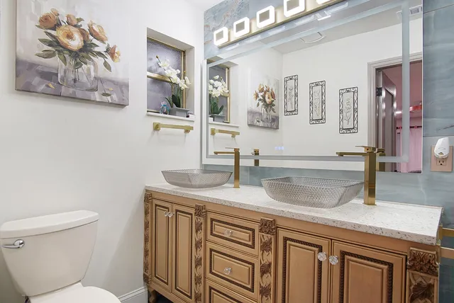 a bathroom with a toilet a sink and mirror