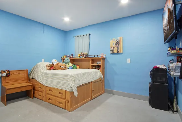 a bedroom with a bed and a couch