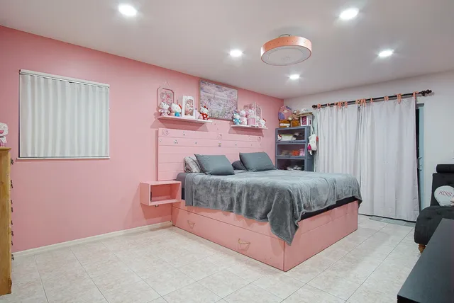 a spacious bedroom with a bed and a couch