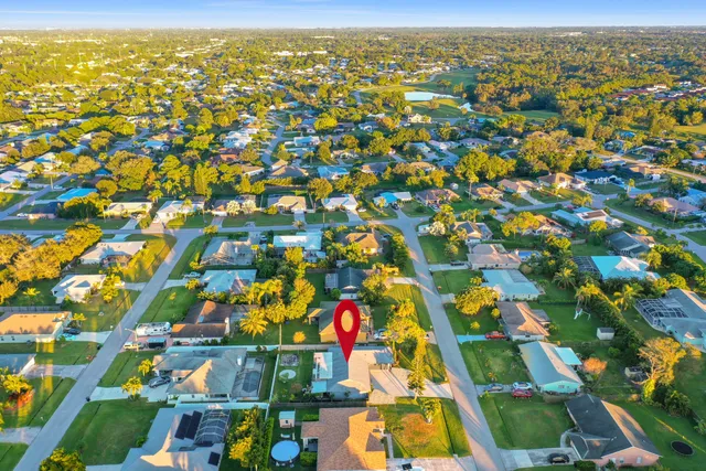 an aerial view of residential houses with outdoor space and parking