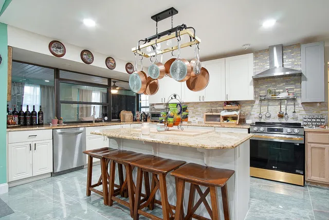 a kitchen with stainless steel appliances granite countertop a stove and cabinets