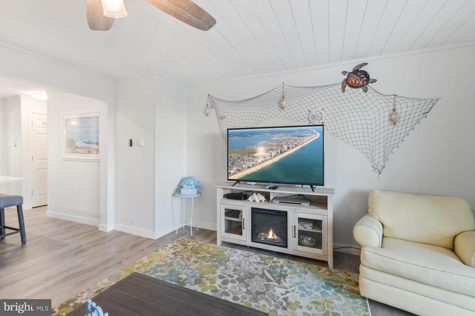 722 Mooring Road, Unit A104 Ocean City, MD 21842 - Photo 14 of 33 a living room with furniture and a flat screen tv