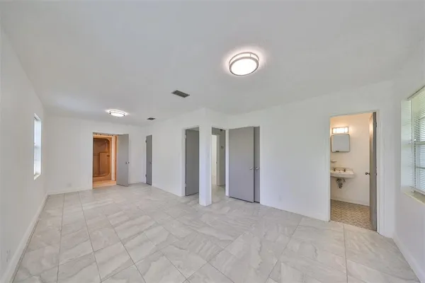 an empty room with closet and a bathroom