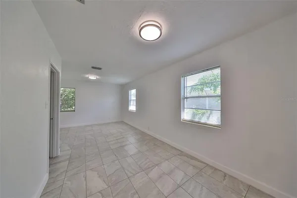 a view of empty room with windows