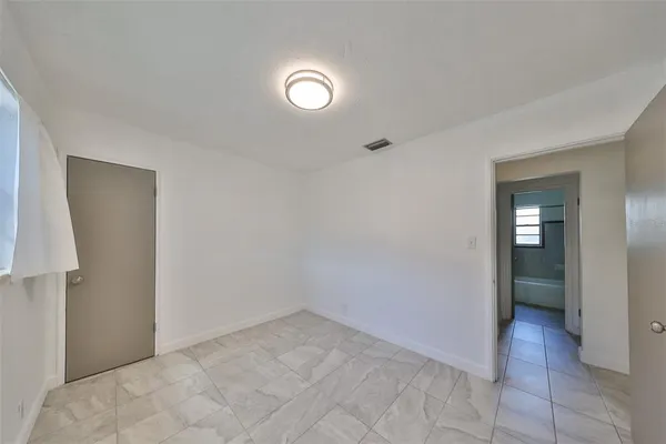 an empty room that has a mirror