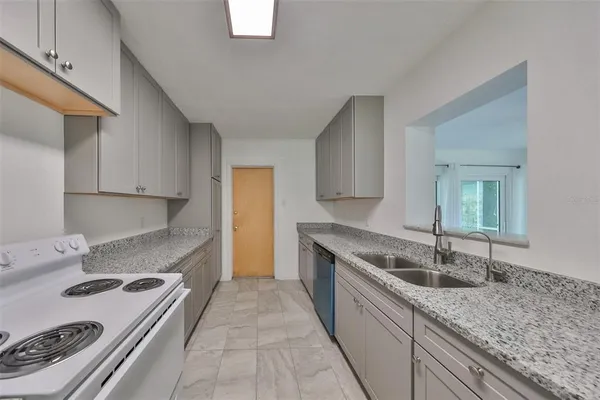 a kitchen with a sink stove and cabinets