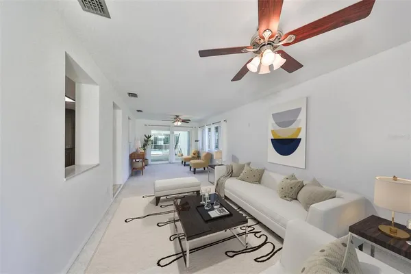 a living room with furniture a rug and a window