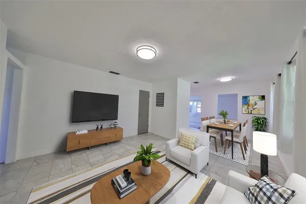 a living room with furniture and a flat screen tv