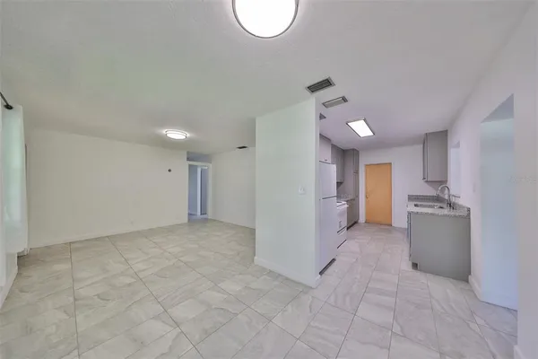 a view of a kitchen with a sink and a cabinet