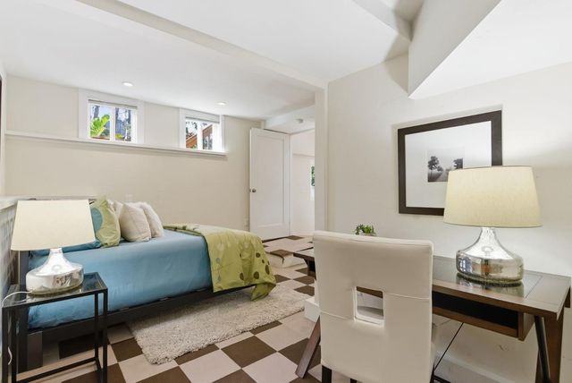 a living room with furniture and a lamp