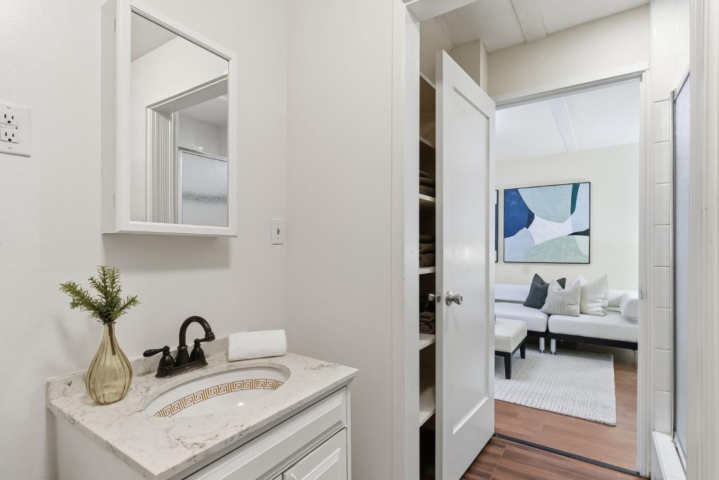 1345 Tuolumne Road Millbrae, CA 94030 - Photo 29 of 44 a bathroom with a granite countertop sink and a mirror