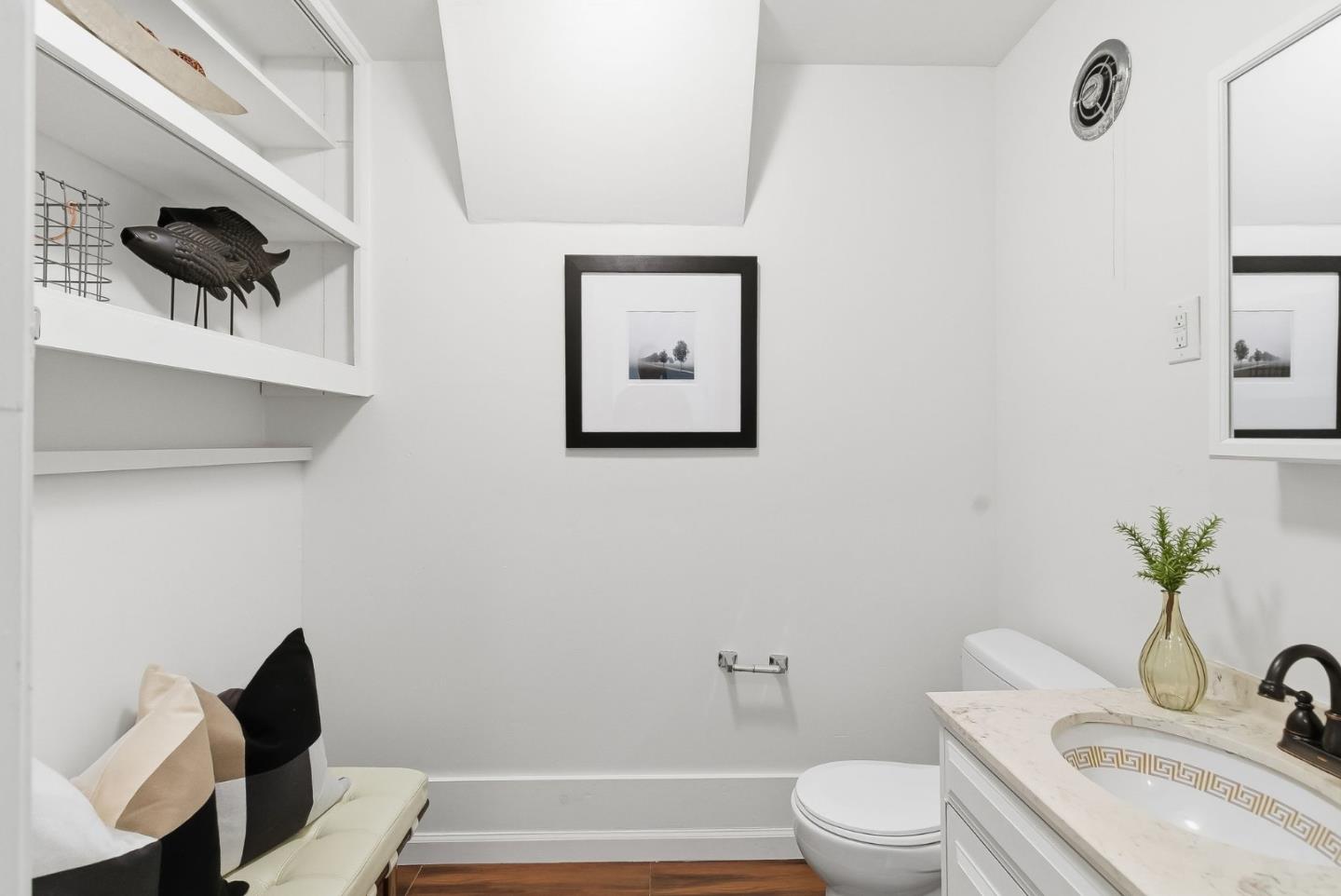 1345 Tuolumne Road Millbrae, CA 94030 - Photo 30 of 44 a bathroom with a toilet a sink and mirror