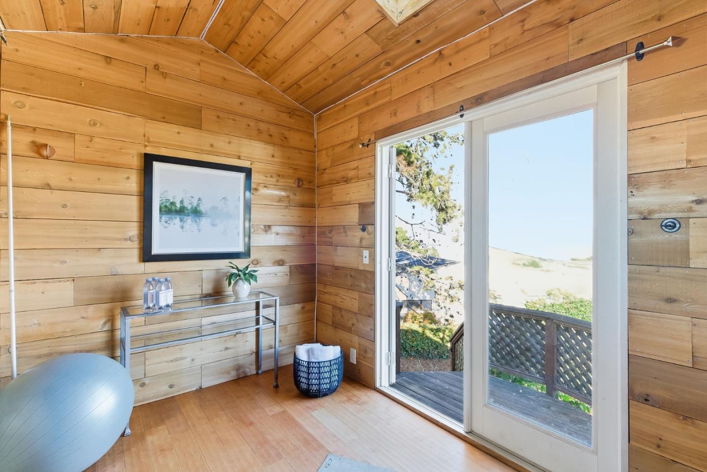 1345 Tuolumne Road Millbrae, CA 94030 - Photo 38 of 44 a room with chairs wooden floor and a potted plant