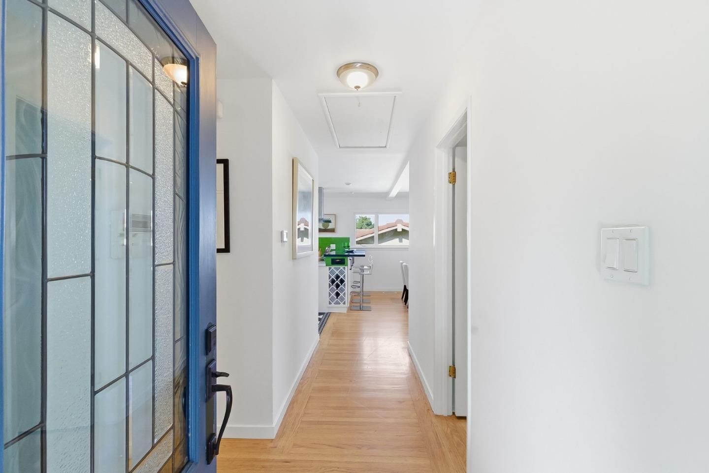1345 Tuolumne Road Millbrae, CA 94030 - Photo 5 of 44 a view of a hallway with wooden floor and a living room