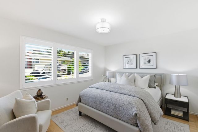 a bedroom with a bed and a couch