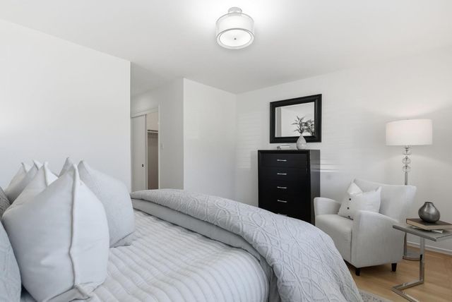 a bedroom with a bed and a lamp