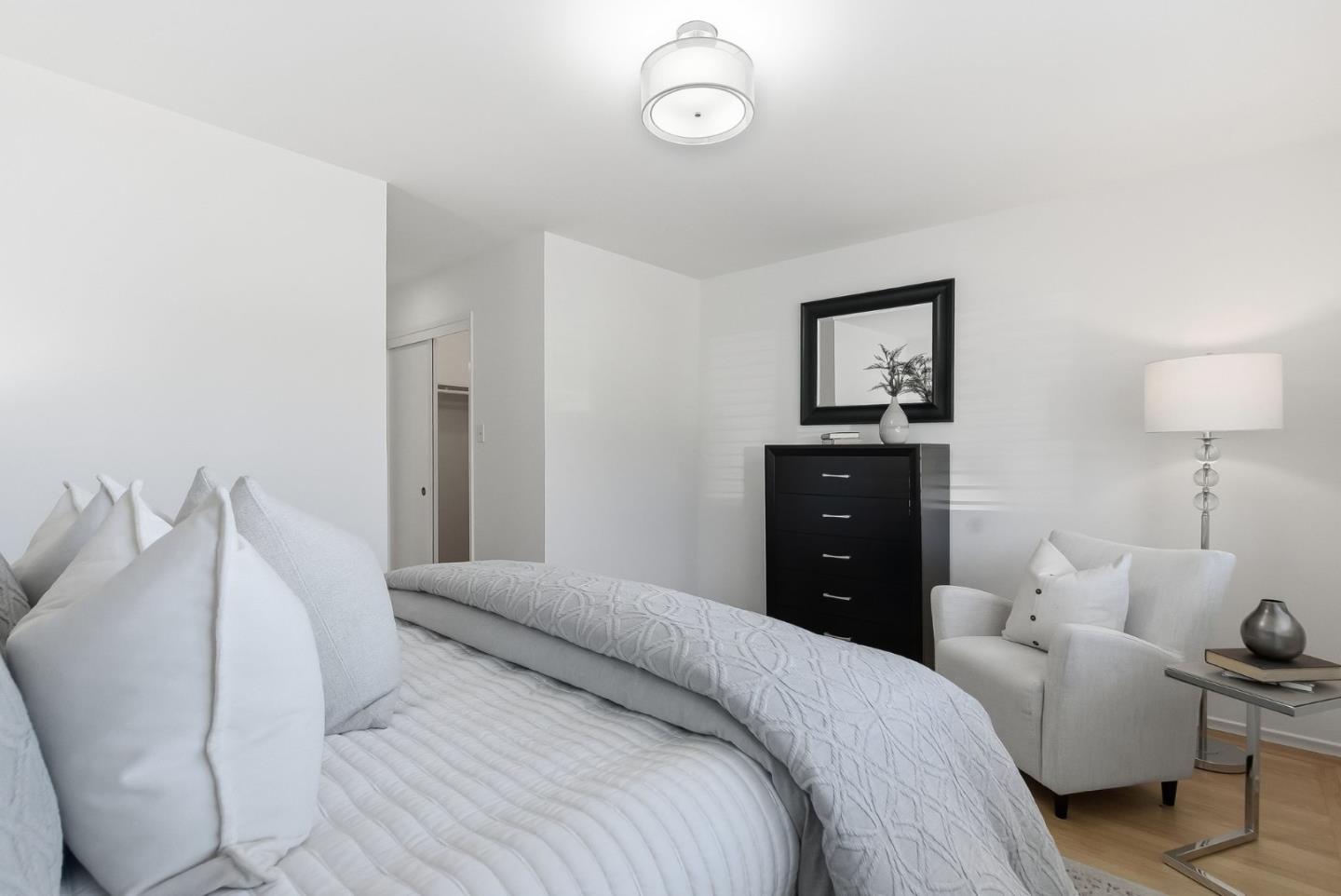 1345 Tuolumne Road Millbrae, CA 94030 - Photo 7 of 44 a bedroom with a bed and a lamp