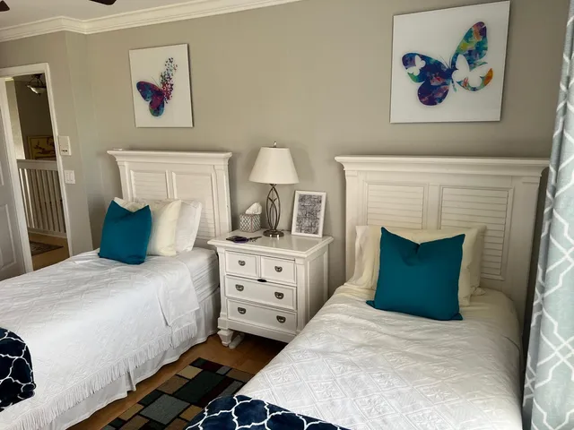 a bedroom with a bed mirror and window