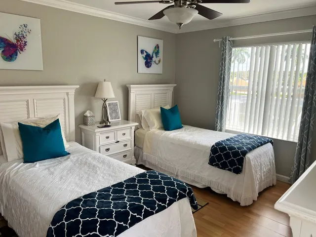 a bedroom with a bed and a large window