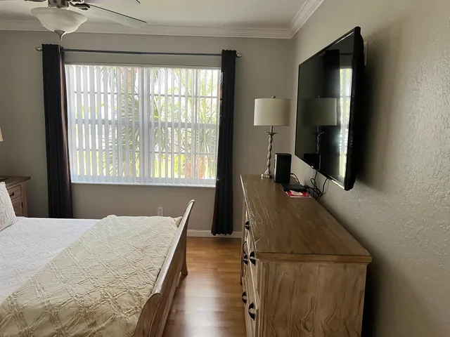 a view of a hallway with wooden floor and stairs