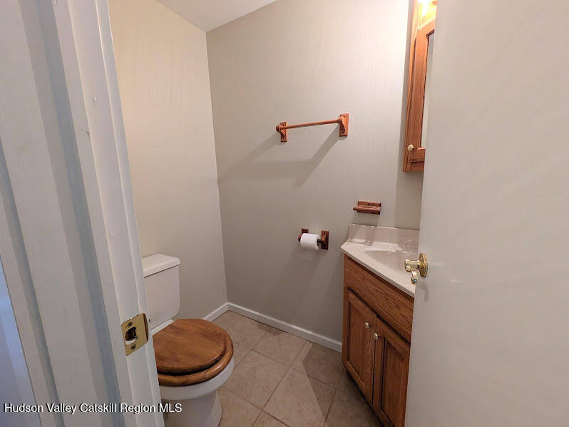 474 Dibble Road Hobart, NY 13788 - Photo 14 of 29 a bathroom with a granite countertop sink and a toilet