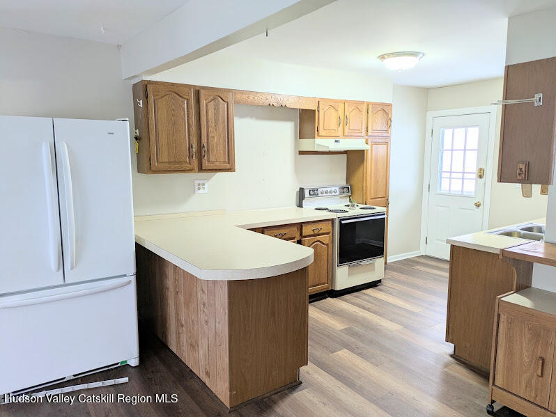 474 Dibble Road Hobart, NY 13788 - Photo 6 of 29 a kitchen with a stove refrigerator sink and dishwasher with wooden floor