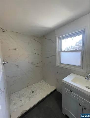 a bathroom with a sink and a window