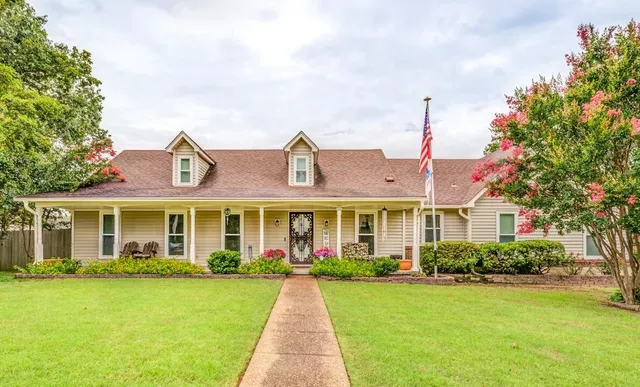 a front view of house with yard and green space