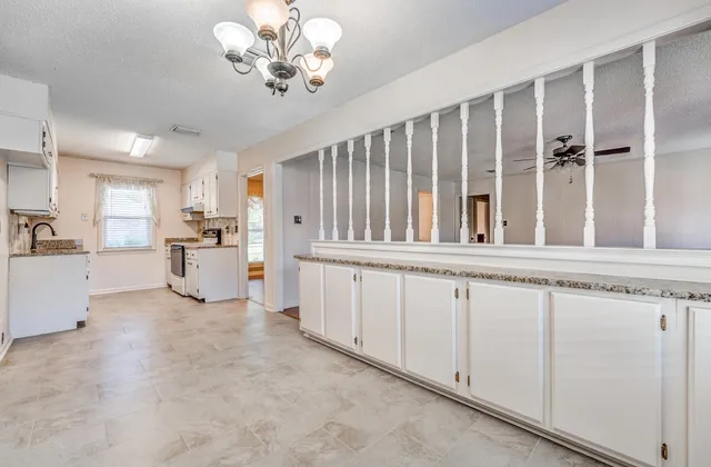 a view of a kitchen with cabinet and windows