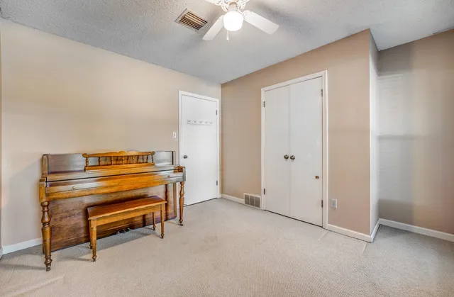a view of room with staircase and ceiling fan