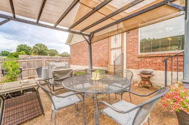 a balcony with furniture and a potted plant