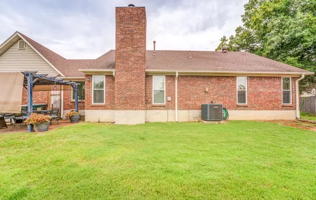 a backyard of a house with table and chairs
