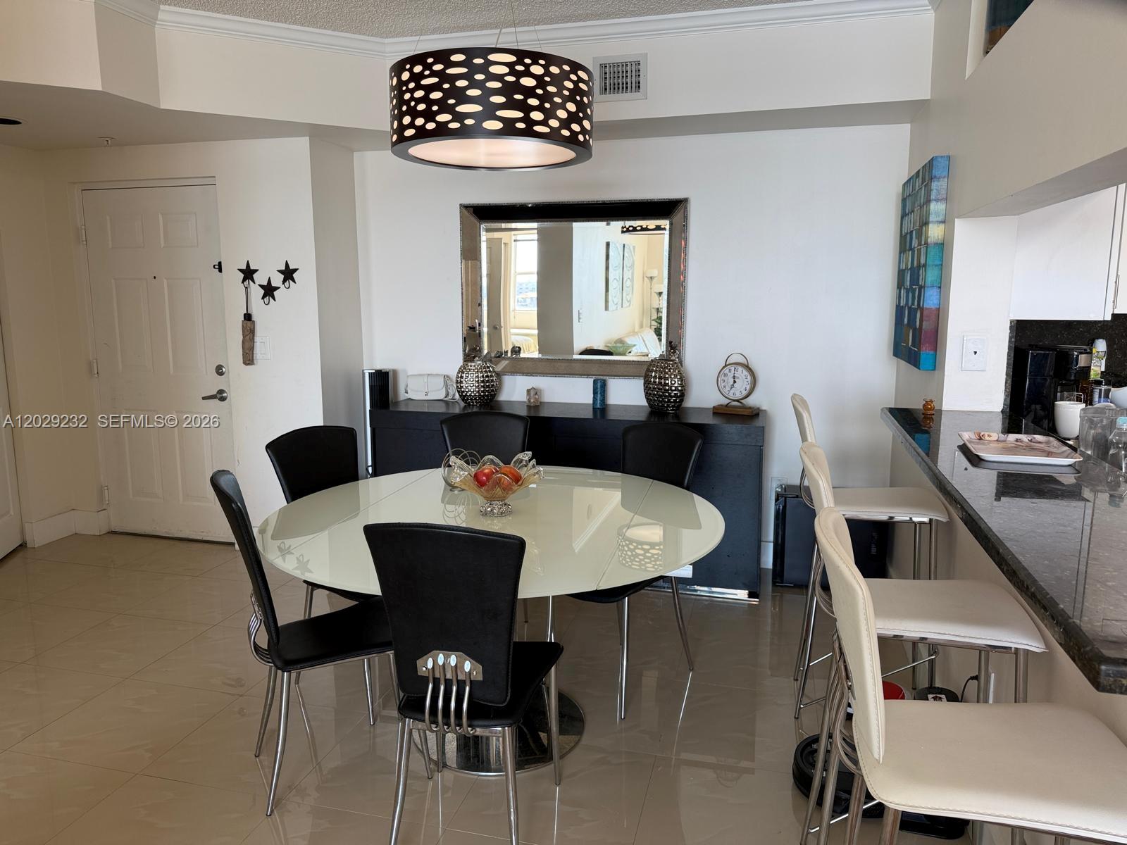 17100 North Bay Road, Unit 1605 Sunny Isles Beach, FL 33160 - Photo 11 of 52 a view of a dining room with furniture