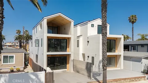 a view of multiple house with palm trees