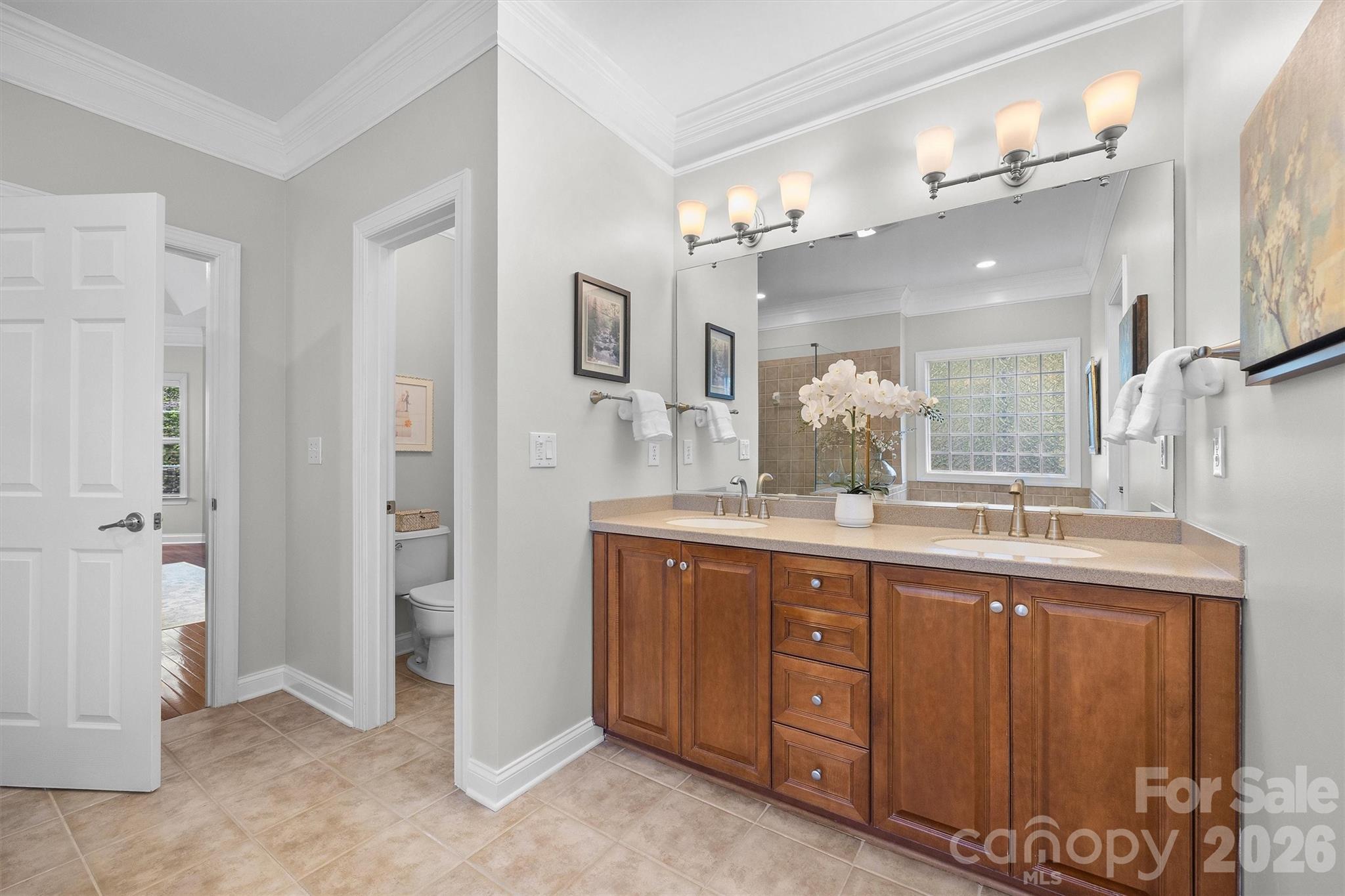 5103 Trinity Trace Lane Monroe, NC 28110 - Photo 25 of 48 a bathroom with a granite countertop sink a mirror and a shower